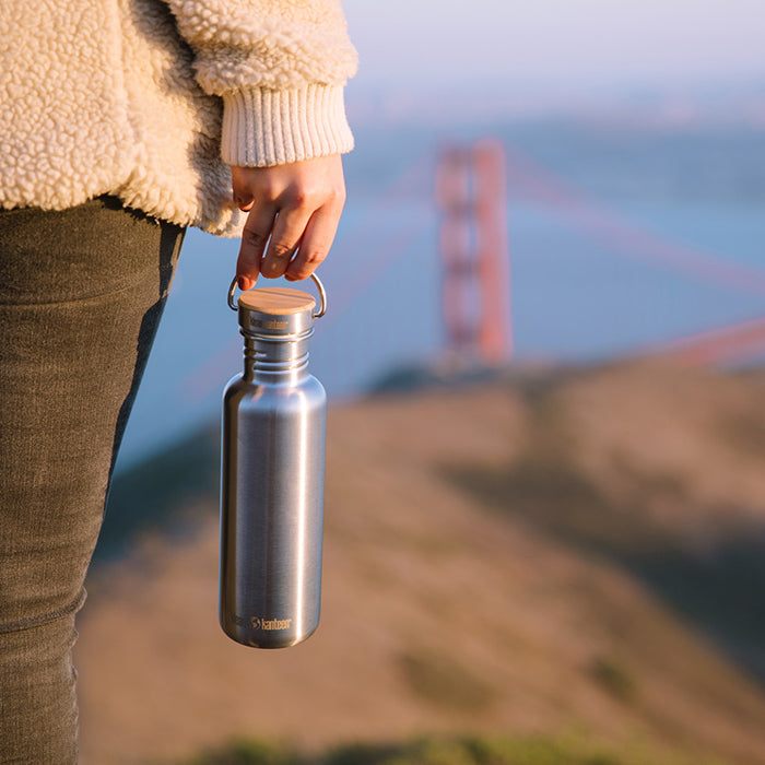 27oz-reflect-with-bamboo-cap-p7 K27SSLRF-BS-BAMBOO_reflect_bottle_bridge_lifestyle.jpg